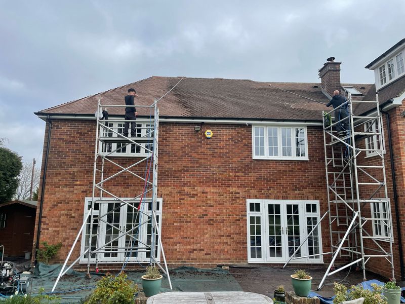 Roof cleaning carried out safely from scaffold towers by The Roof Moss Cleaners in Kempston